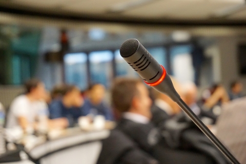 Close up image of a microphone on a podium